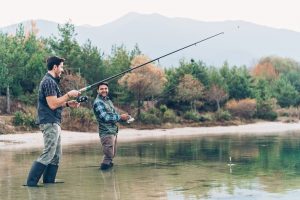 Two men fishing by the river